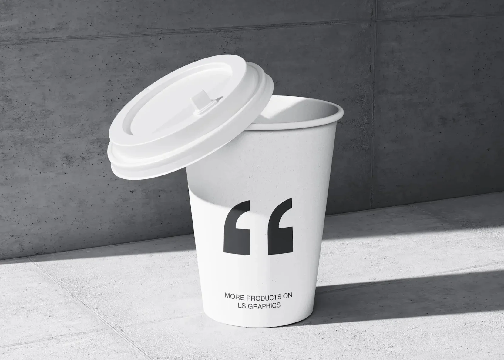 A white cup with a lid sitting on a concrete floor.